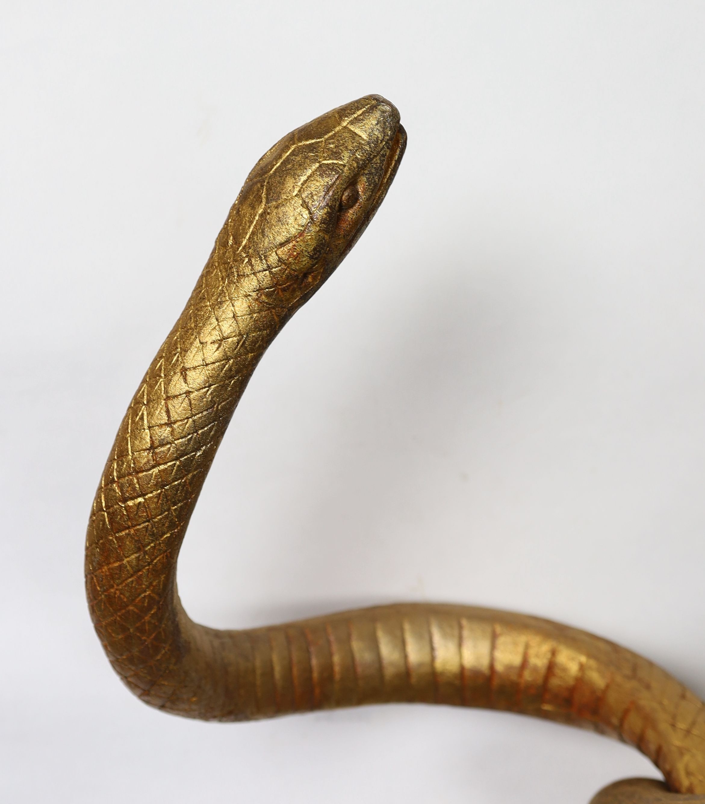 After Edgar Brandt. A gilt cast iron group of two entwined snakes, width 66cm height 121cm